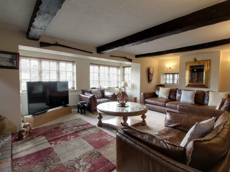 At the heart of the £700,000-plus home is this spacious lounge, made stunning by its exposed stonework and beams to the ceiling. Windows at the front, side and back of the property allow a plentiful amount of natural light.