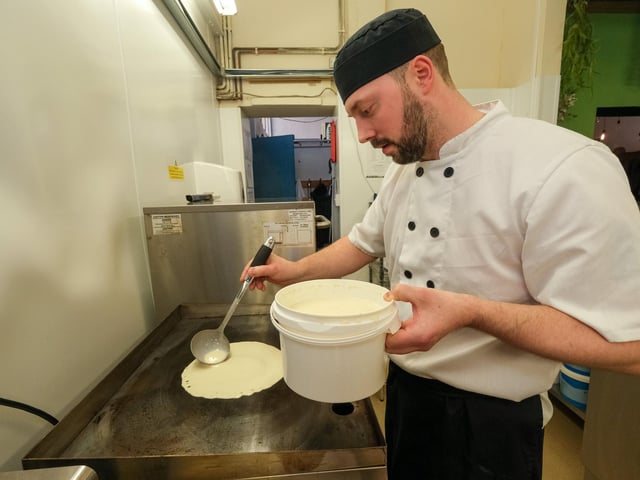 Next, Carl spooned out the mixture onto a hotplate (a hot pan will also work), making a shallow circle.