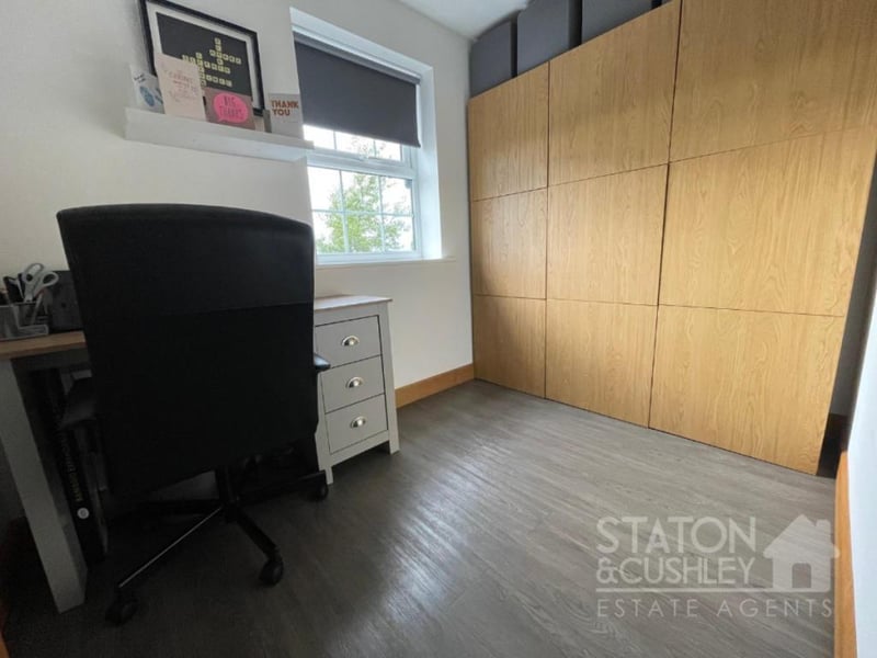 This bedroom can easily be converted into a home office or study.