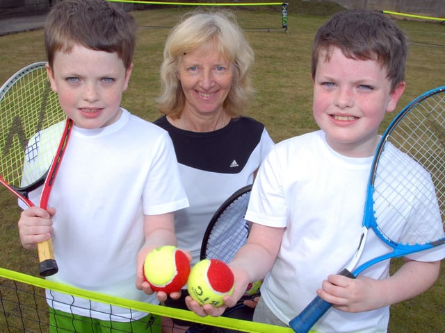 A Mansfield Lawn Tennis Club Open Day is enjoyed by twins, 9 year old Harry, left, and Jack Blackwell, with club member Ann Brown, who won the Wimbledon Veterans title in 2010 for the second time.