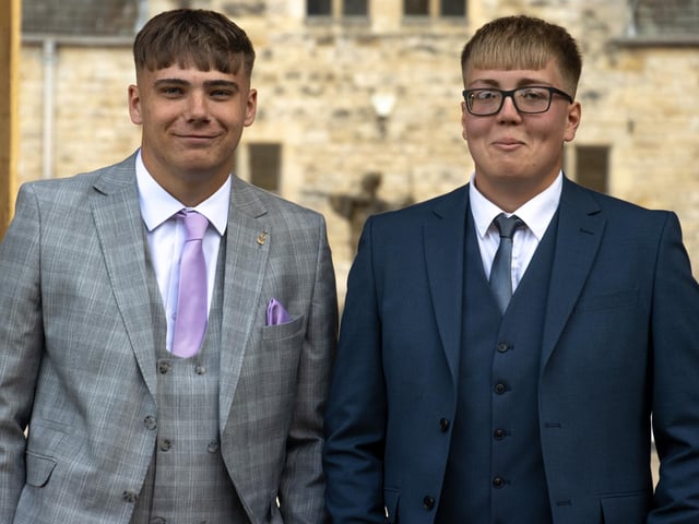 Students wearing some impressive suits at the glamorous prom event.