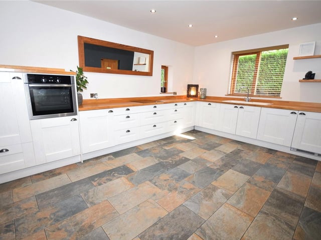 The stylish, newly-fitted dining kitchen is fitted with a range of units, a solid wood worktop and a one-and-a-half-bowl ceramic sink. Integrated appliances include an oven, four-ring hob, fridge, freezer, dishwasher, washing machine and tumble dryer. There is also a tiled floor, a country-style stable door leading to a patio, and space for a dining table
