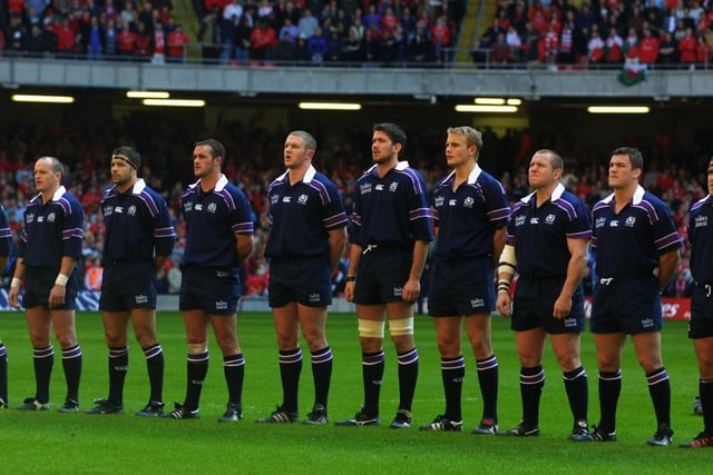 Scotland players Gregor Townsend, Budge Pountney, Martin Leslie, Jason White, Scott Murray, Simon Taylor, Mattie Stewart and Gordon Bulloch line up for the anthems before the 2002 Six Nations Championship match against Wales at the Millennium Stadium, in Cardiff.