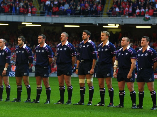 Scotland players Gregor Townsend, Budge Pountney, Martin Leslie, Jason White, Scott Murray, Simon Taylor, Mattie Stewart and Gordon Bulloch line up for the anthems before the 2002 Six Nations Championship match against Wales at the Millennium Stadium, in Cardiff.