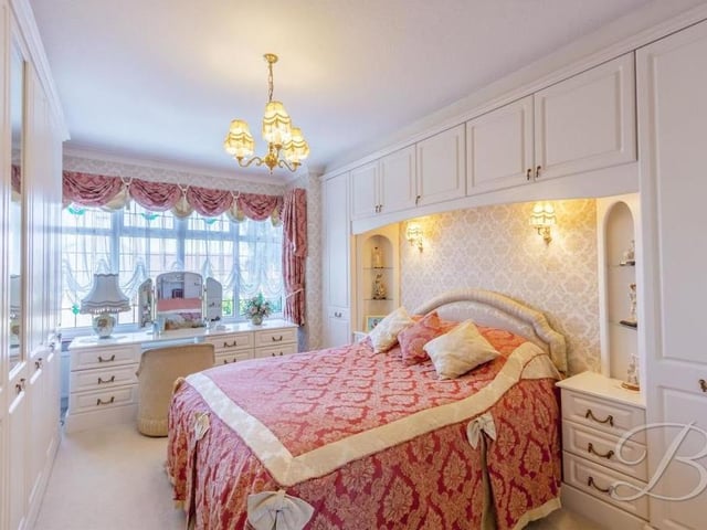 This bedroom also comes with fitted wardrobes and has space for a dressing table by the window that overlooks the front of the house.