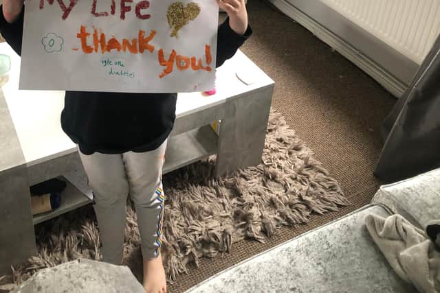 Lilly with her message of thanks to staff at King's Mill Hospital