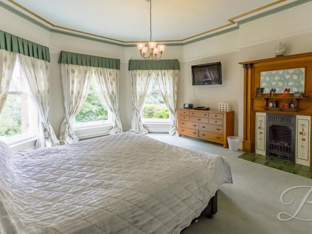 As you can see, the master bedroom benefits from three superb bay windows, offering natural light and terrific views of the property's grounds.