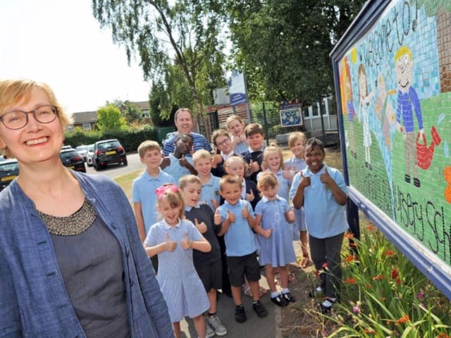 Pupils from Abbey Hill with head teacher Helen Chambers and chairman of School Governors, Karl Simpson, are all smiles after their 'Good' Ofsted report in 2014.