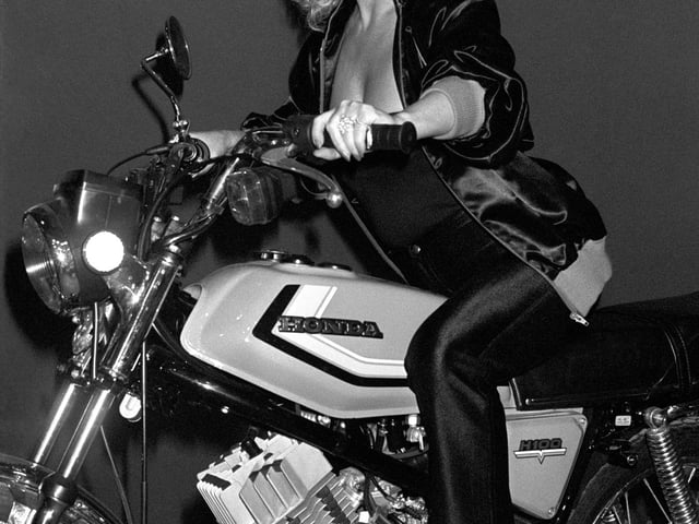Barbara Windsor on the Honda 100A, a 100cc commuter bike. She was visiting the International Motor Show at Earles Court in London i n 1980.