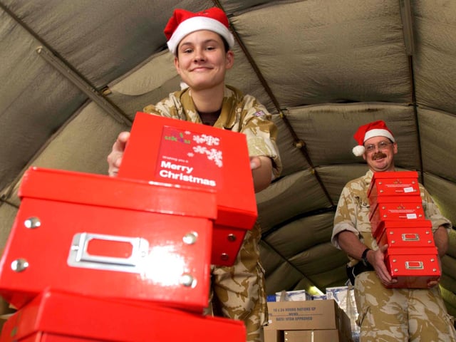 Senior Aircraft Woman Emma Yates aged 19 from Doncaster (Normally based at RAF Kinloss) made short work of sorting the Christmas boxes for troops on the  117 Accommodations unit, Basrah Iraq in 2005. Pictured with Flight Sergeant Roger Keen aged 46 from Lincoln (Normally based at RAF Waddington)