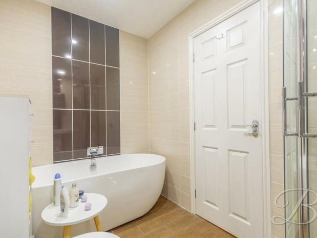 The last room to inspect at the Mansfield house is the family bathroom, complete with a fitted, free-standing bath with waterfall tap.