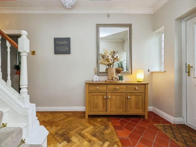 A welcoming entrance hallway sets the tone, with understairs storage and stairs rising to the first floor.