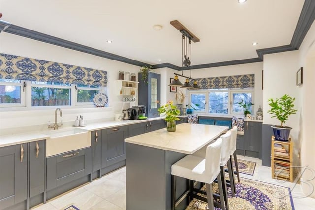 First stop on our photo tour of the house is this attractive kitchen, which comes complete with a breakfast bar and a Belfast sink and drainer with mixer tap, not to mention underfloor heating. It is fitted with a range of gorgeous, shaker-style wall and base units with quartz worktops.
