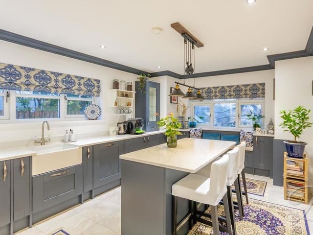 First stop on our photo tour of the house is this attractive kitchen, which comes complete with a breakfast bar and a Belfast sink and drainer with mixer tap, not to mention underfloor heating. It is fitted with a range of gorgeous, shaker-style wall and base units with quartz worktops.
