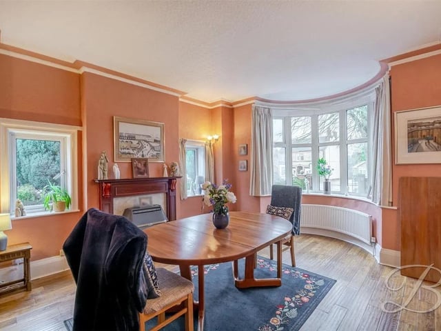 An impressive and generously proportioned room, beautifully appointed with hardwood flooring, central heating radiator, elegant twin windows to the side elevation and a striking bay window to the front of the property, enjoying picturesque views over the front lawn.