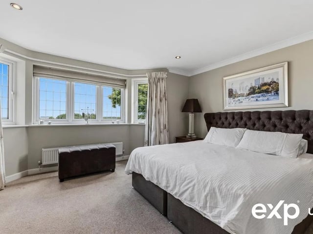 This stunning room overlooks the leafy vista of open fields with continued far-reaching views.