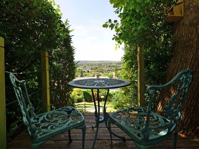 A small decked terrace sits within the trees, strategically positioned to take advantage of the far reaching views.