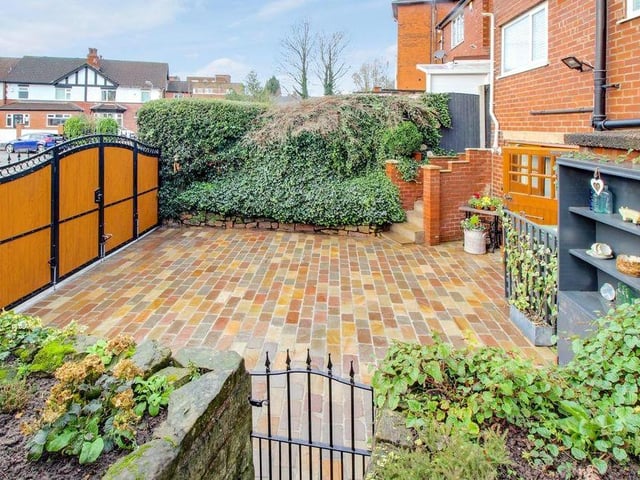 The exterior of the property is as polished as the interior. This image shows the block-paved driveway at the front, which is gated.