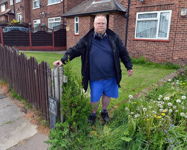 Tenant Tony Eaton by the gap that has been left since the removal of the hedge at his Mansfield home.