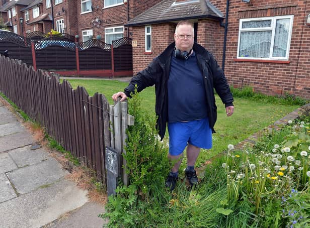 Tenant Tony Eaton by the gap that has been left since the removal of the hedge at his Mansfield home.