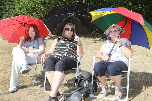 Katie, Tracy and Anna Sanders take shelter from the sun