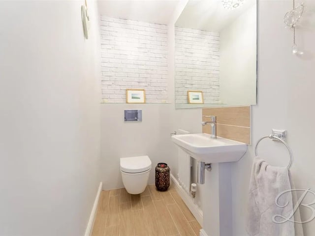 The WC is fitted with a low flush toilet and a hand wash basin, offering a convenient and functional space.