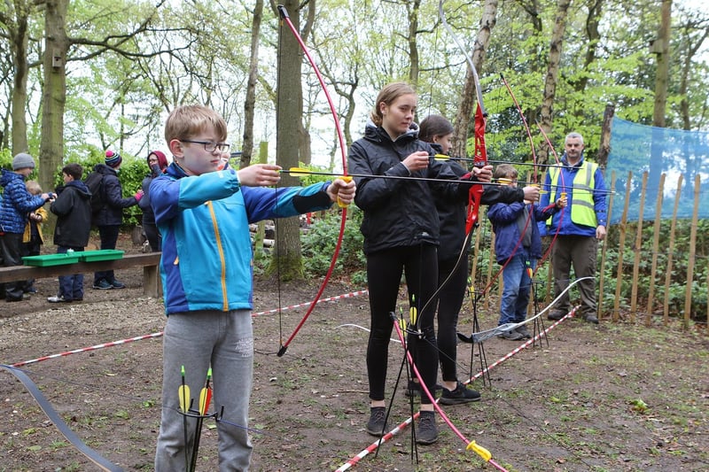 Mansfield scouts try their hand at archery at a scout camp.
