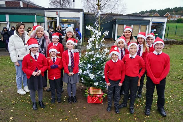 Presentation of a Christmas tree from the Lashes Foundation to Newlands school. 
Children, teachers and members of Lashes Foundation at the carol singing around the tree event.