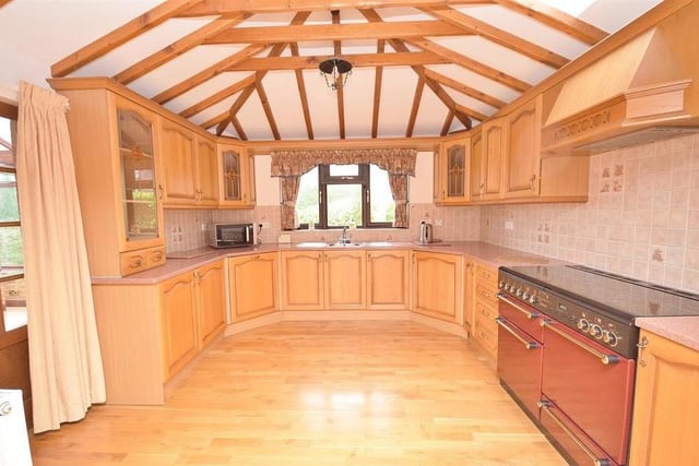 With its spectacular array of beams and high vaulted ceiling, the kitchen must be unique. It offers a range of wall and base units, with a stainless steel sink and drainer, plus an integrated dishwasher and integrated fridge. There is also space for a gas range cooker, while double doors lead through to the conservatory.