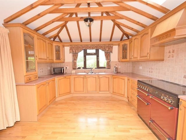 With its spectacular array of beams and high vaulted ceiling, the kitchen must be unique. It offers a range of wall and base units, with a stainless steel sink and drainer, plus an integrated dishwasher and integrated fridge. There is also space for a gas range cooker, while double doors lead through to the conservatory.