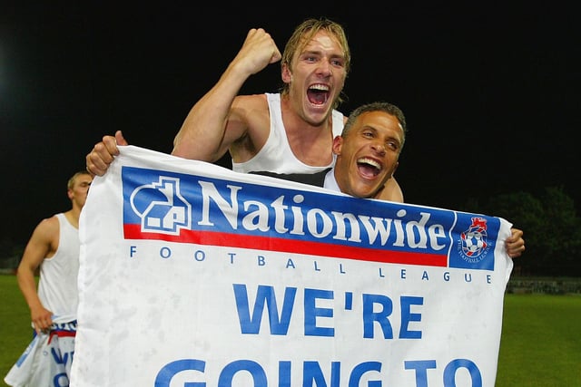 Liam Lawrence and player-manager Keith Curle of Mansfield celebrate.
