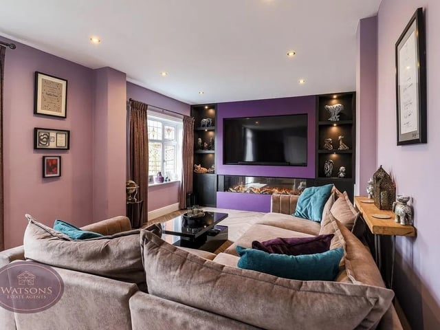 The property boasts a spacious lounge with feature fireplace and French doors opening onto the rear garden.