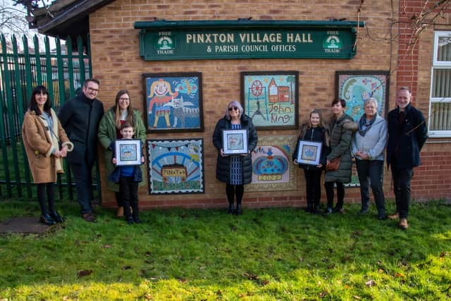 Jane Wells of Junction Arts, Anthony and Victoria Walkington with son Freddie, Anne Ingle, headteacher of Pinxton Village Academies, holding Hunter Neal’s work, Ruby Allard and mum Michelle Stain, Coun Mary Dooley and Coun Julian Siddle