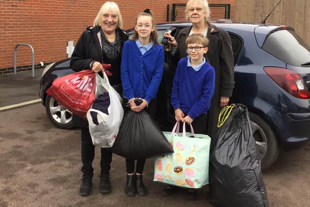 Year six pupils Taigan and Ethan making a donation to Eastwood People's Initative.