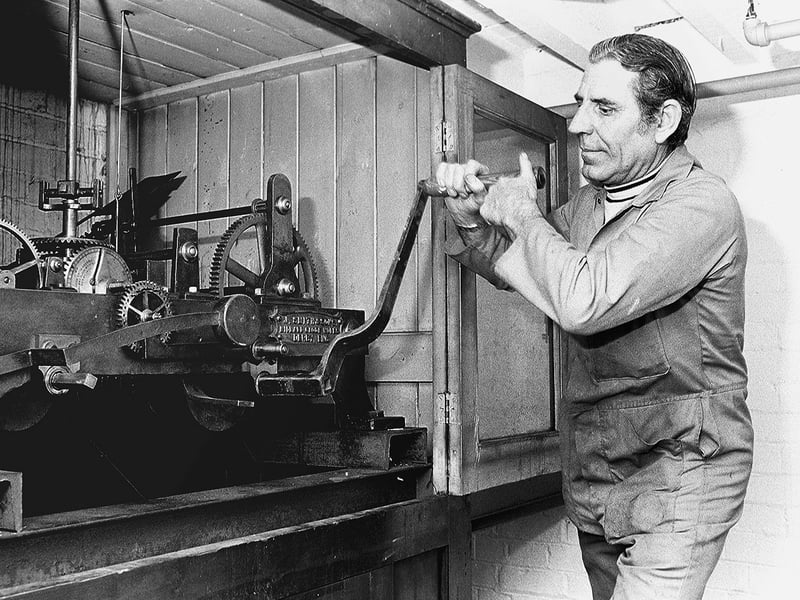 George Bird winds the clock above the Metal Box Factory in Mansfield in 1977.