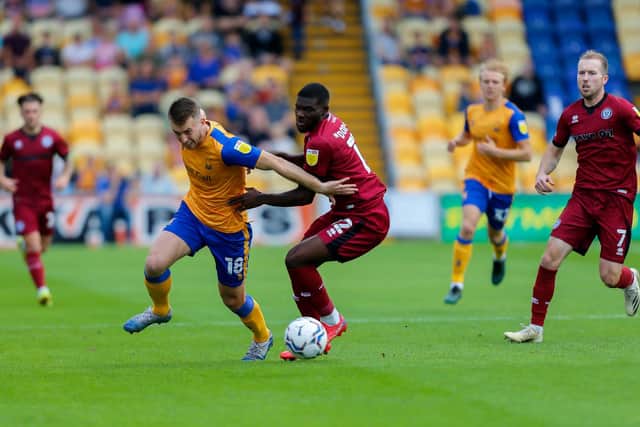 Mansfield Town forward Rhys Oates battles with Rochdale defender Jeriel Dorsett. Pic Chris Holloway / The Bigger Picture.media