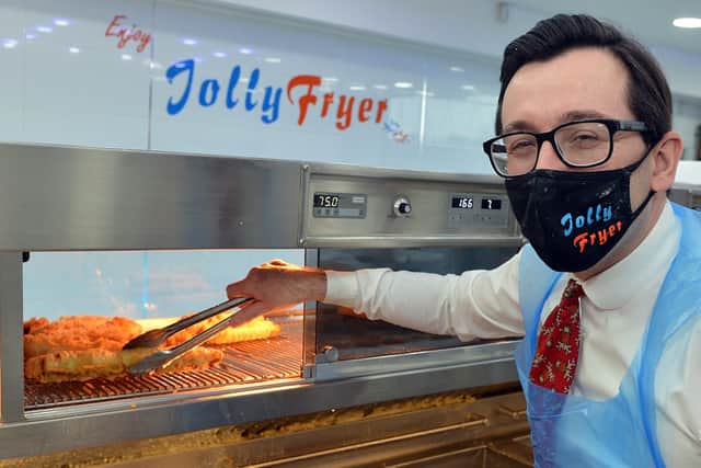 Jolly Frier owner Theo Tsiolas prepares to serve some battered pigs in blankets.