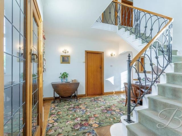 As you step inside the Forest Hill property, you are greeted by this stunning entrance hall, with its winding staircase and spacious storage cupboard and cloakroom.