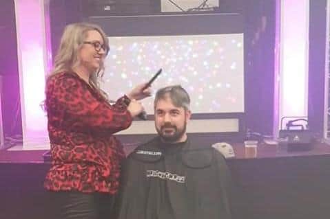 Nicola Crew shaving Kevin Potter's head during the fundraiser