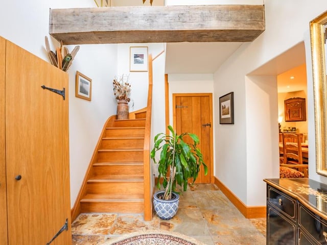 Much of the aesthetic character of the property is encapsulated in the hallway, which gives a sense of homeliness. It also contains the staircase that leads us up to the first floor.