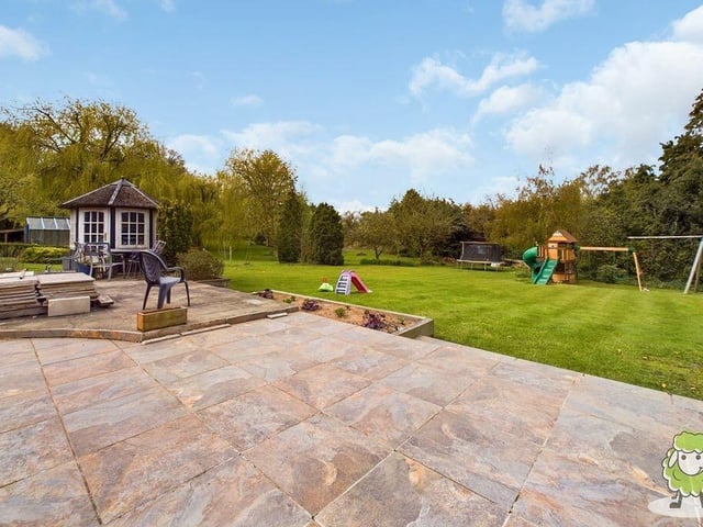 Te back garden provides a pleasant mix of patio and lawn.