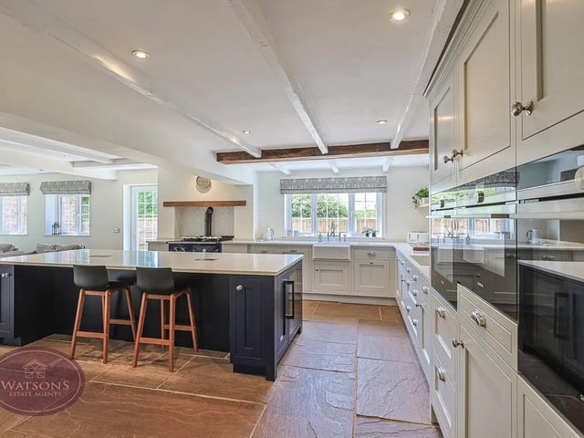 The kitchen features a number of integrated appliances including waist height electric double over, grill, induction hob with extractor over, range cooker, microwave, wine cooler and dishwasher.
