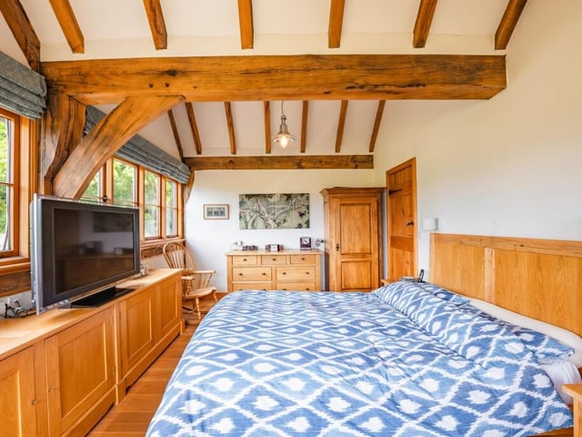 The first of the four bedrooms to take a look at on the first floor is the marvellous master. It is cosy but its exposed oak frames and vaulted ceiling give it a dramatic edge.