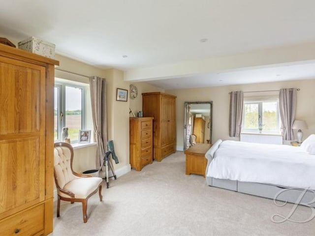The master bedroom is a wonderful blend of style and space. It has a carpeted floor and windows to the front and side of the property.