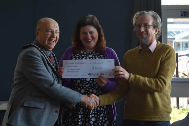 Coun Tom Munro, Bolsover Council chairman, presents a cheque to Whitwell Forward from the grants scheme. (Photo by: Bolsover Council)
