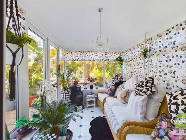 Flowing seamlessly from the dining room is this super sun room, which offers panoramic views of the property's amazing tropical garden. French doors open on to that garden too,