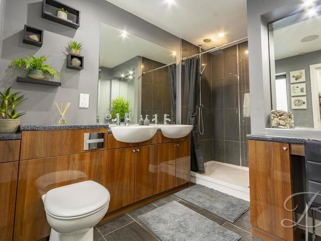 The en suite to the master bedroom oozes luxury. Comprising an enclosed shower, double wash hand basin with vanity unit for storage and low-flush WC, it is also fitted with a heated mirror, downlights, tiled flooring and chrome, heated towel-rail.