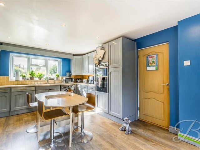 The kitchen is complete with a range of matching cabinetry, inset sink and drainer, integrated appliances and decorative splashback tiles. Window to the front elevation and patio doors opening to the rear garden. Not to mention there is plenty of space for your dining furniture.