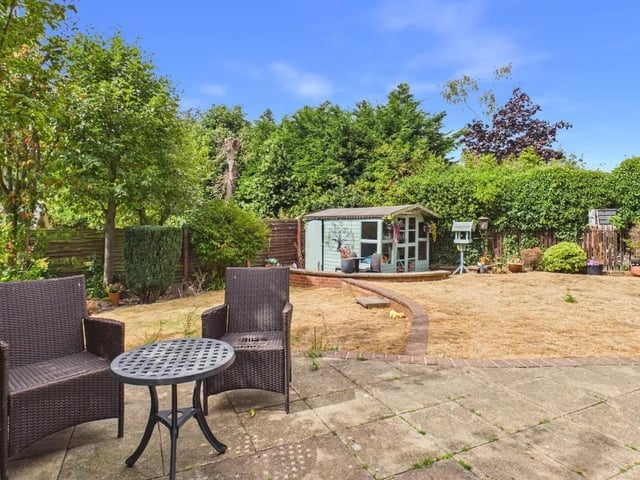 To the rear, you will find a generous, westerly-facing lawned garden complete with a large patio area, a summerhouse, mature fruit trees, external power points and water access.