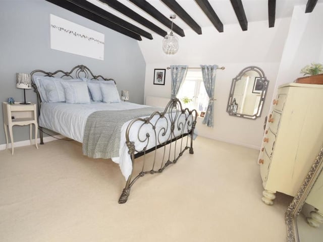The main bedroom form a different angle. It has a really sophisticated ambience to it and features a fitted wardrobe.